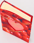 Red photo album with cherry design on a white background