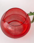 top view of Apple glass pitcher with ribbed texture and green handle on a white background
