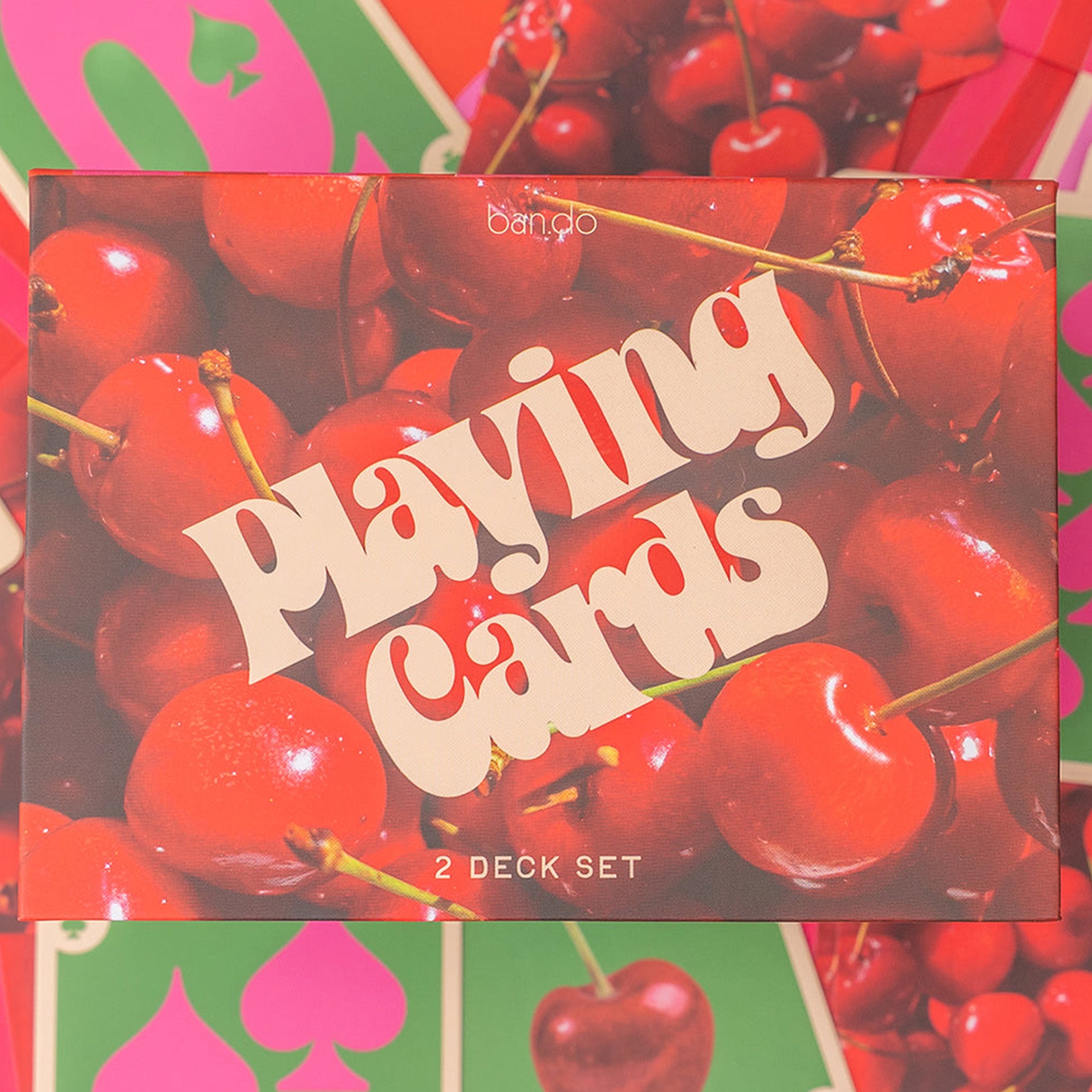 Playing cards set with cherry design on the packaging