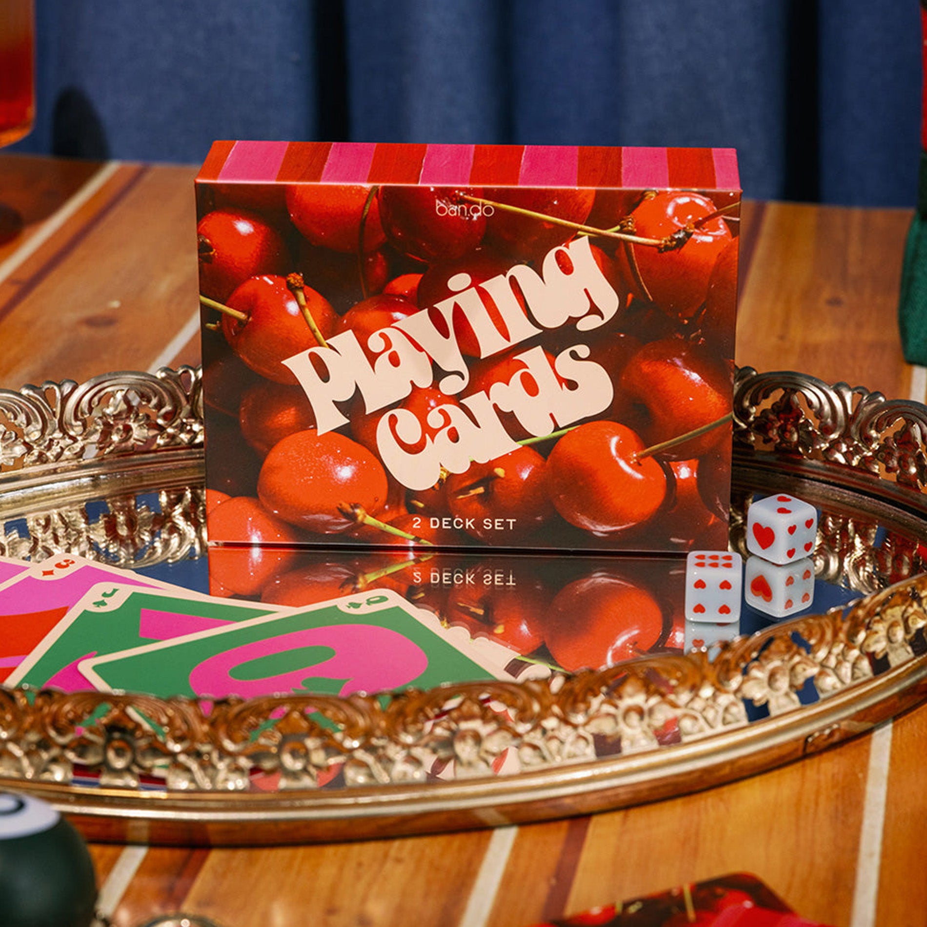 Playing card set with cherry design on a decorative tray