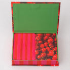 Colorful box with a green lid, pink and red striped paper, and cherry design.