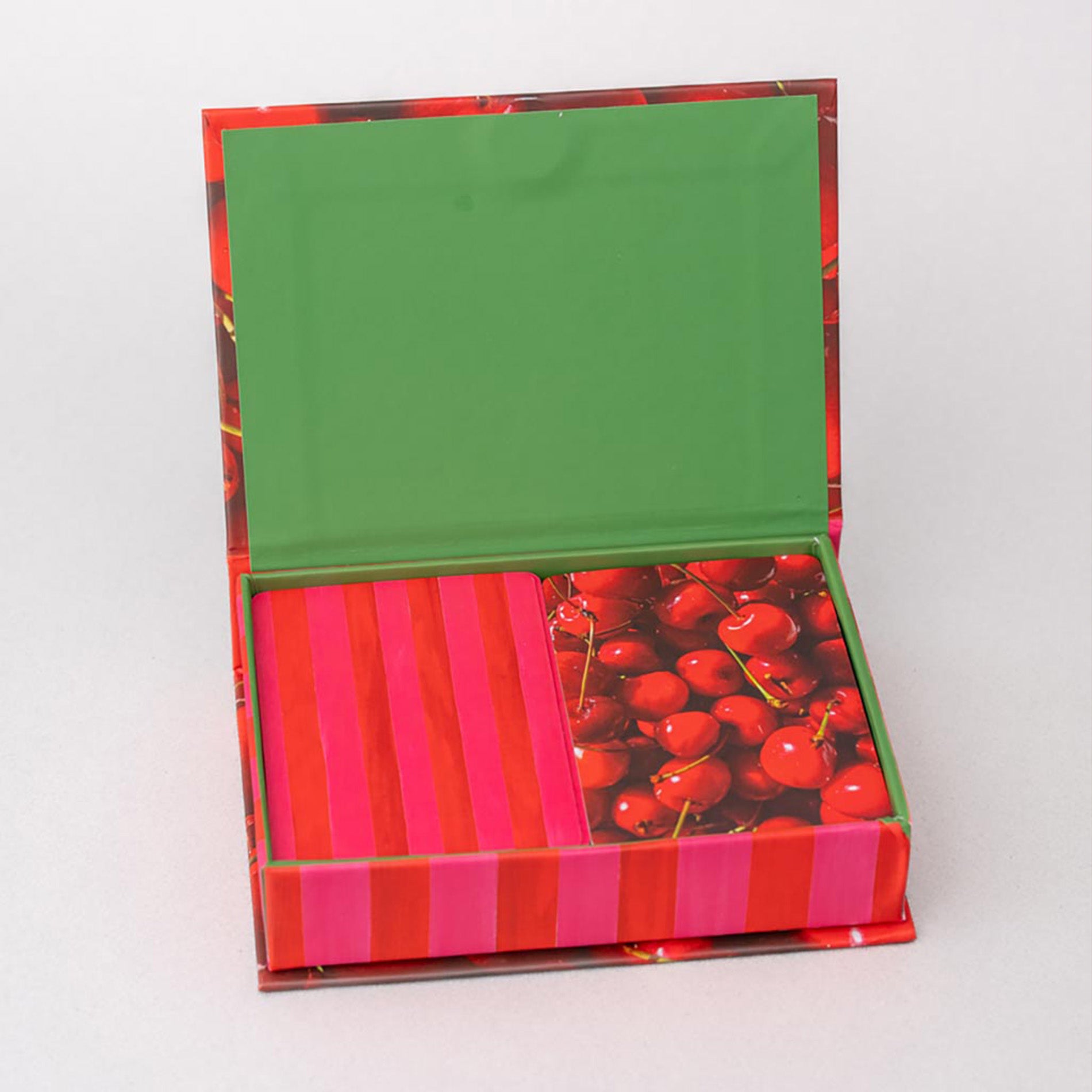 Colorful box with a green lid, red and pink striped sides, and cherry design on a white background.