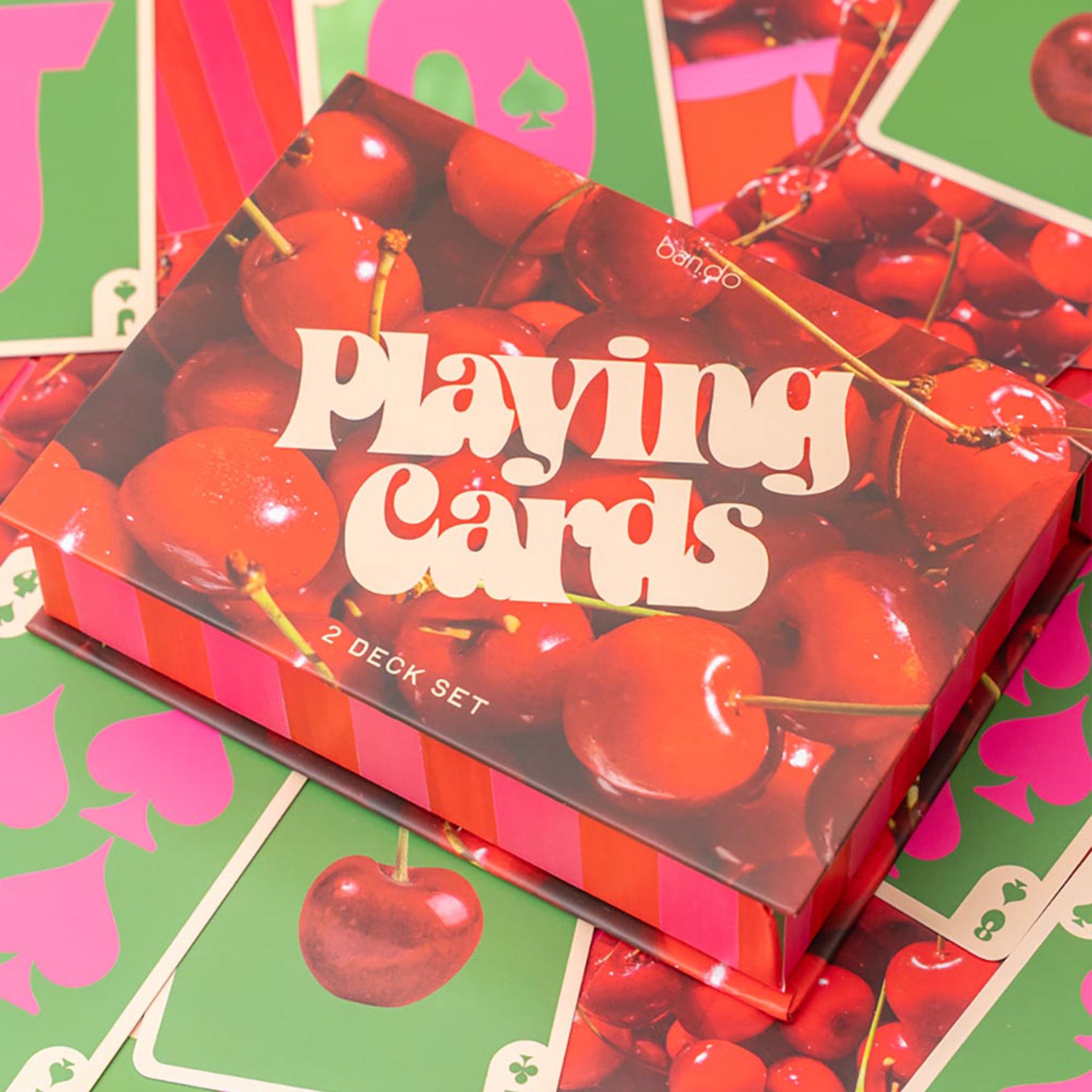 Playing card set with cherry design on a colorful background