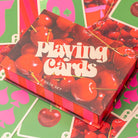 Playing card set with cherry design on a colorful background