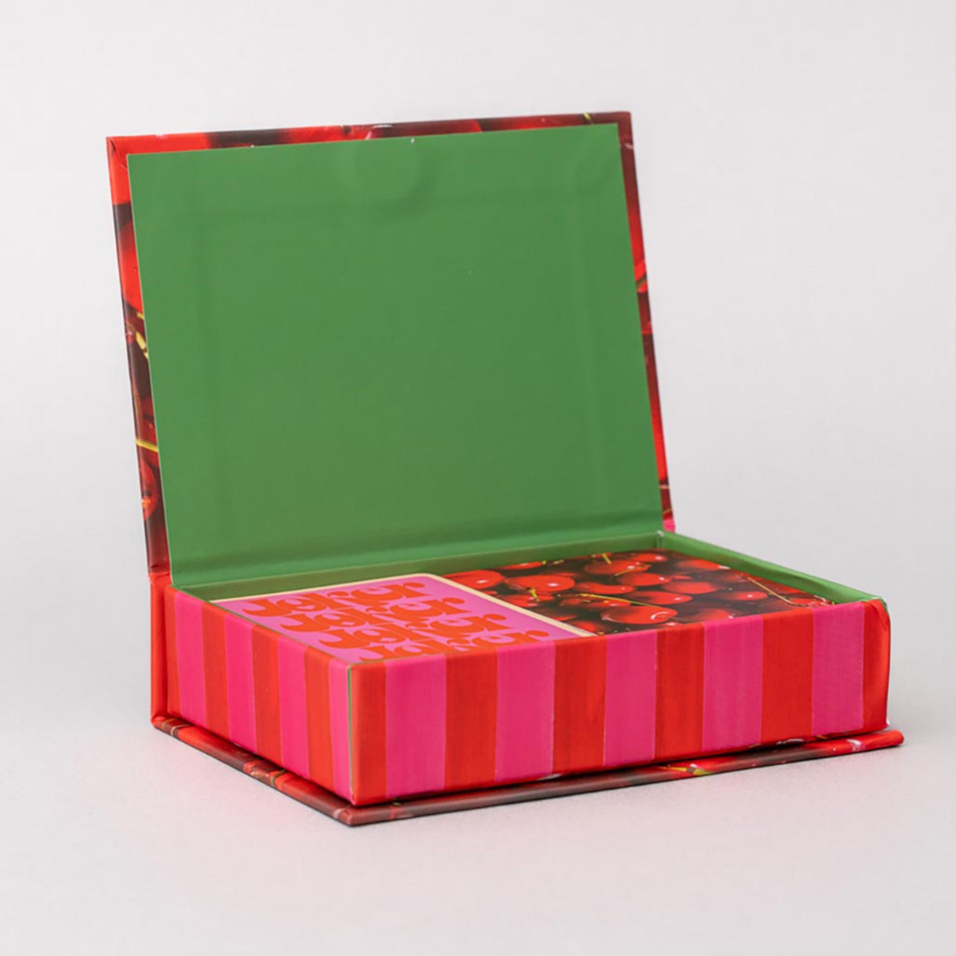 Colorful box with a green lid and pink and red striped base on a white background