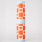 roll up checkers and backgammon with orange and white checkered pattern and blue accents on a light gray background