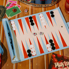 Backgammon board with pieces and dice on a wooden table