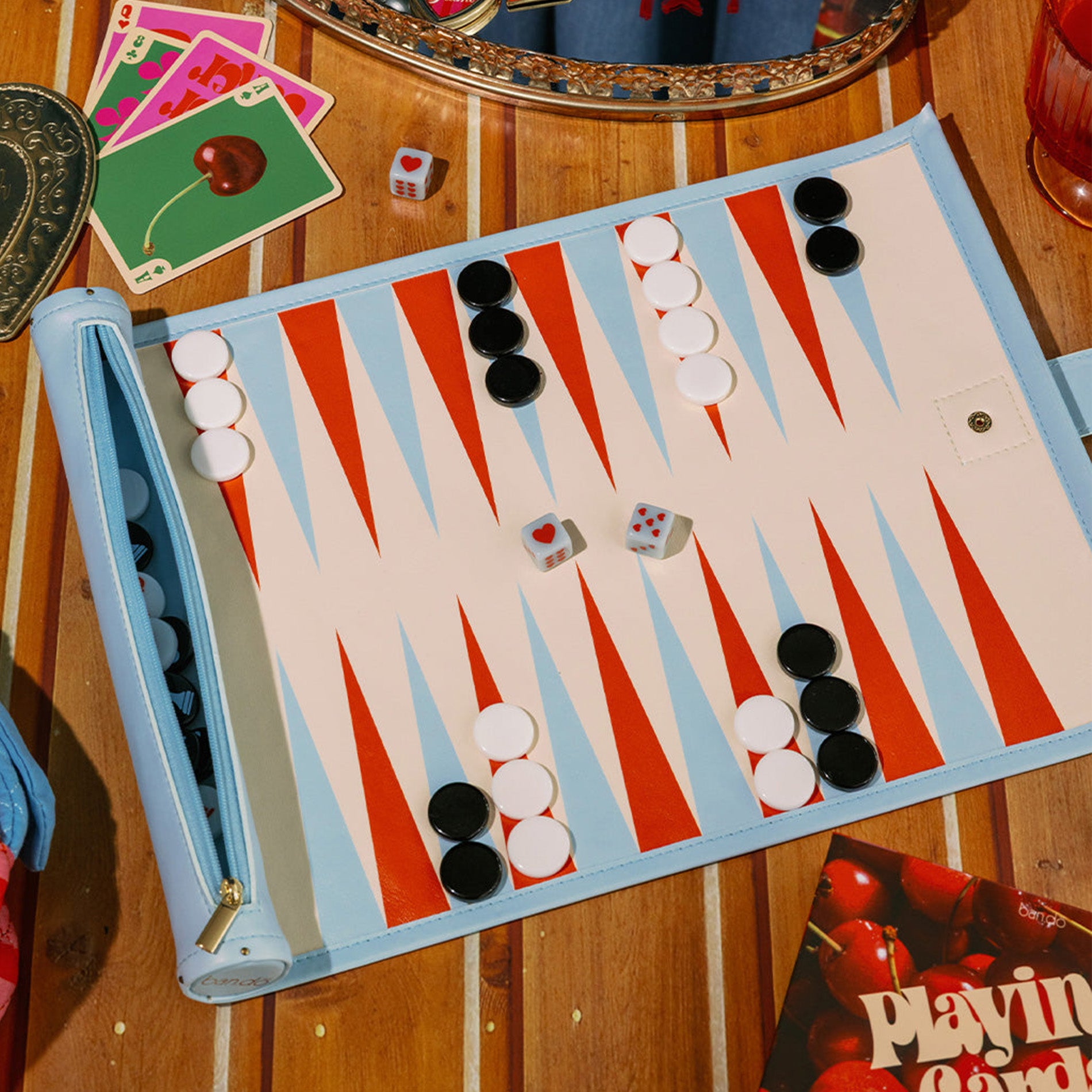 Backgammon board with pieces and dice on a wooden table