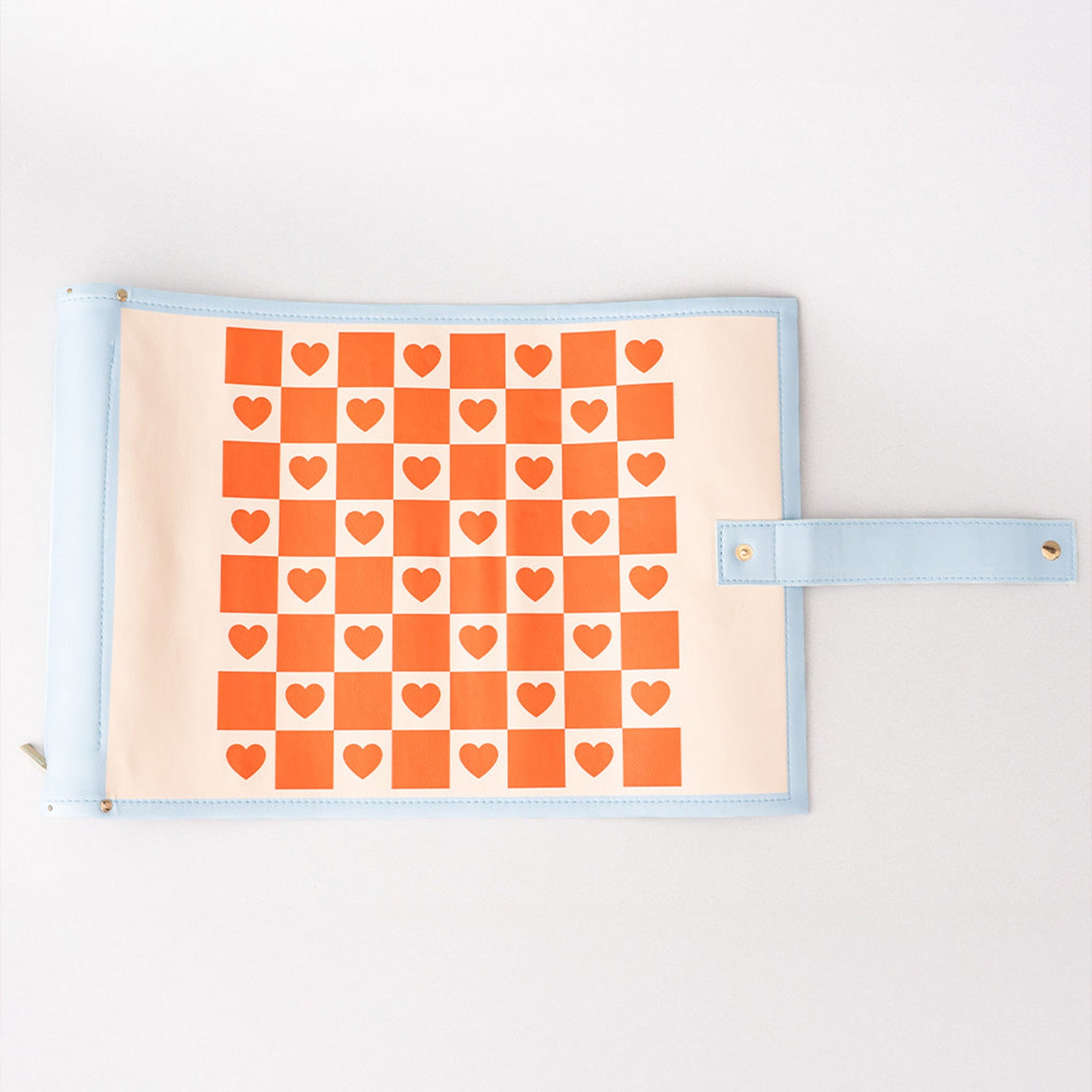 roll up checkers and backgammon with orange heart pattern on a beige background