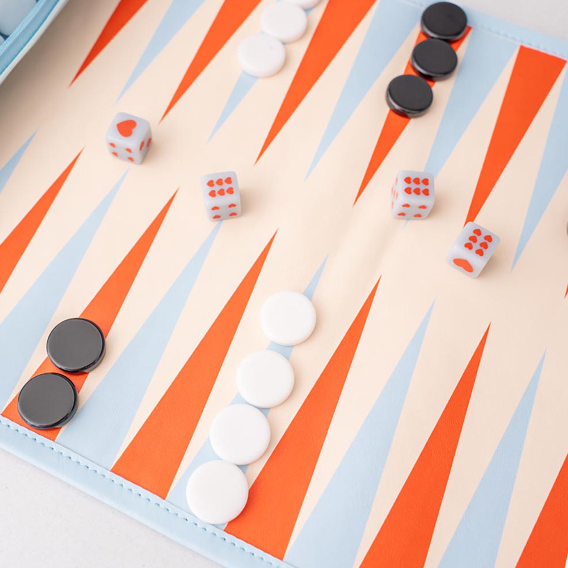 Backgammon board with pieces and dice on a light background