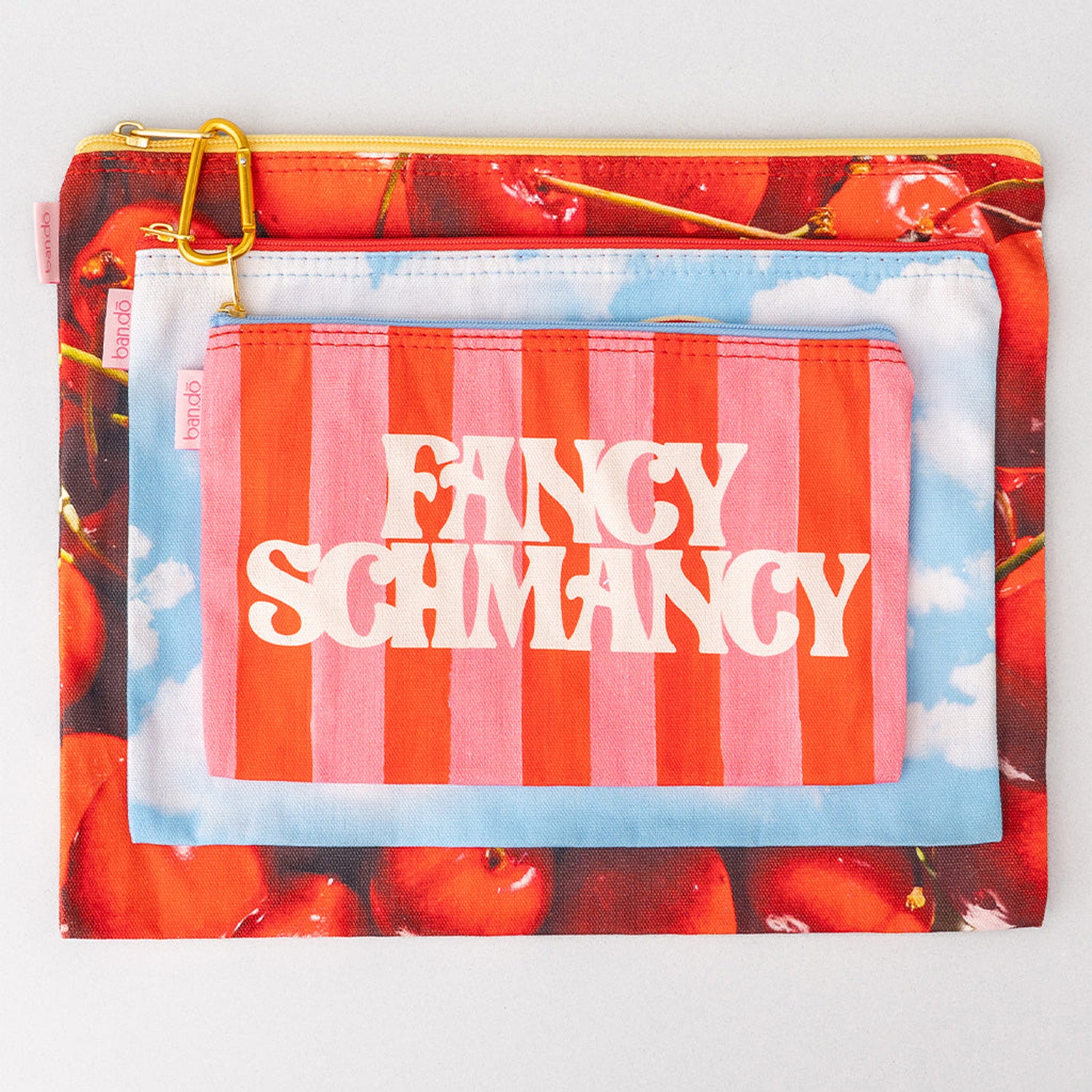 Pouch with cherry design and 'Fancy Schmancy' text on a white background