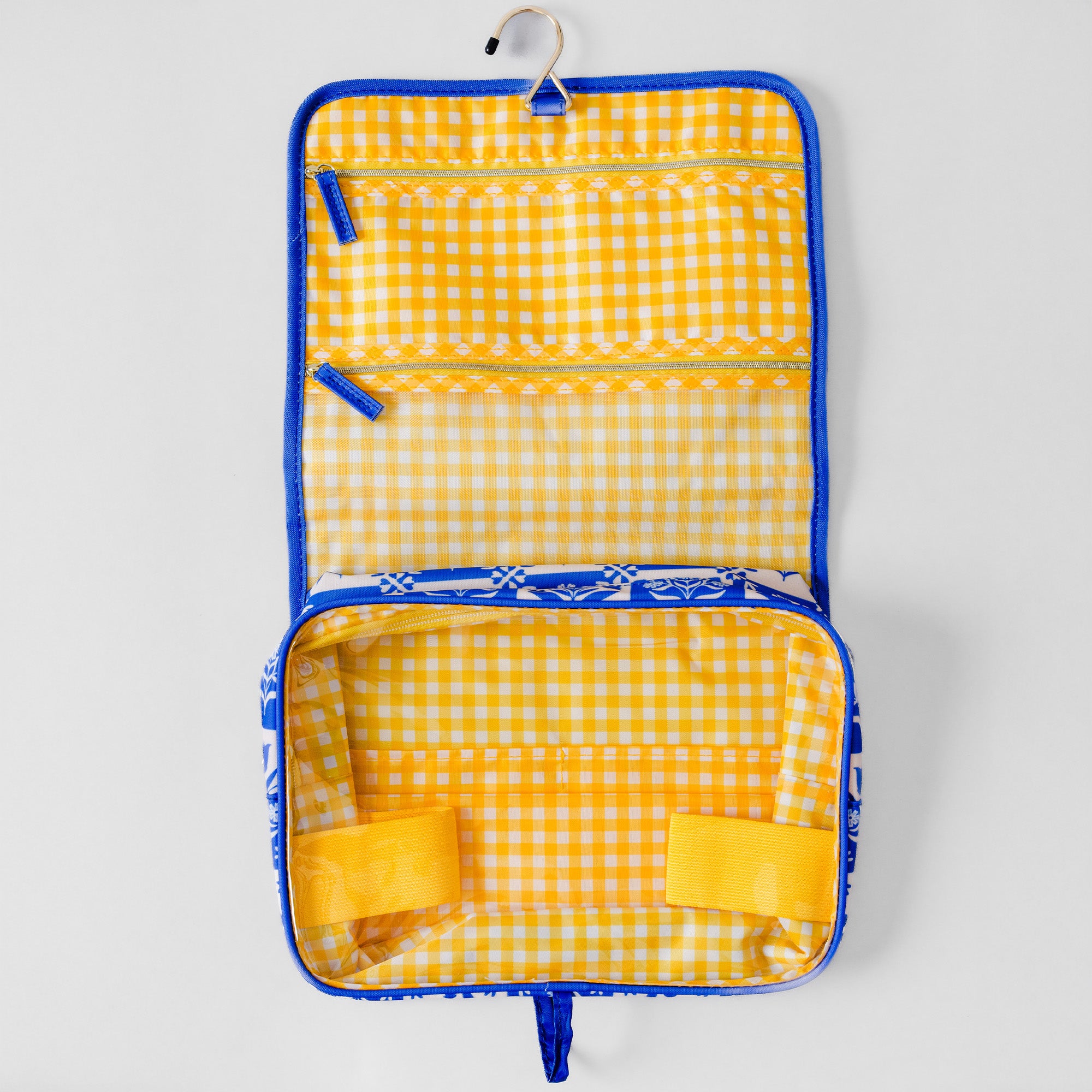 A yellow and white gingham check hanging organizer bag with blue trim, shown open on a light gray background.