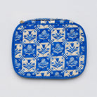 A quilted zippered pouch featuring a blue and cream floral tile pattern, photographed flat against a light gray background.