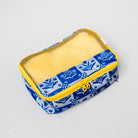A rectangular fabric pouch with a blue and white floral patterned exterior, a yellow mesh window, and a yellow zipper, shown on a light gray background.