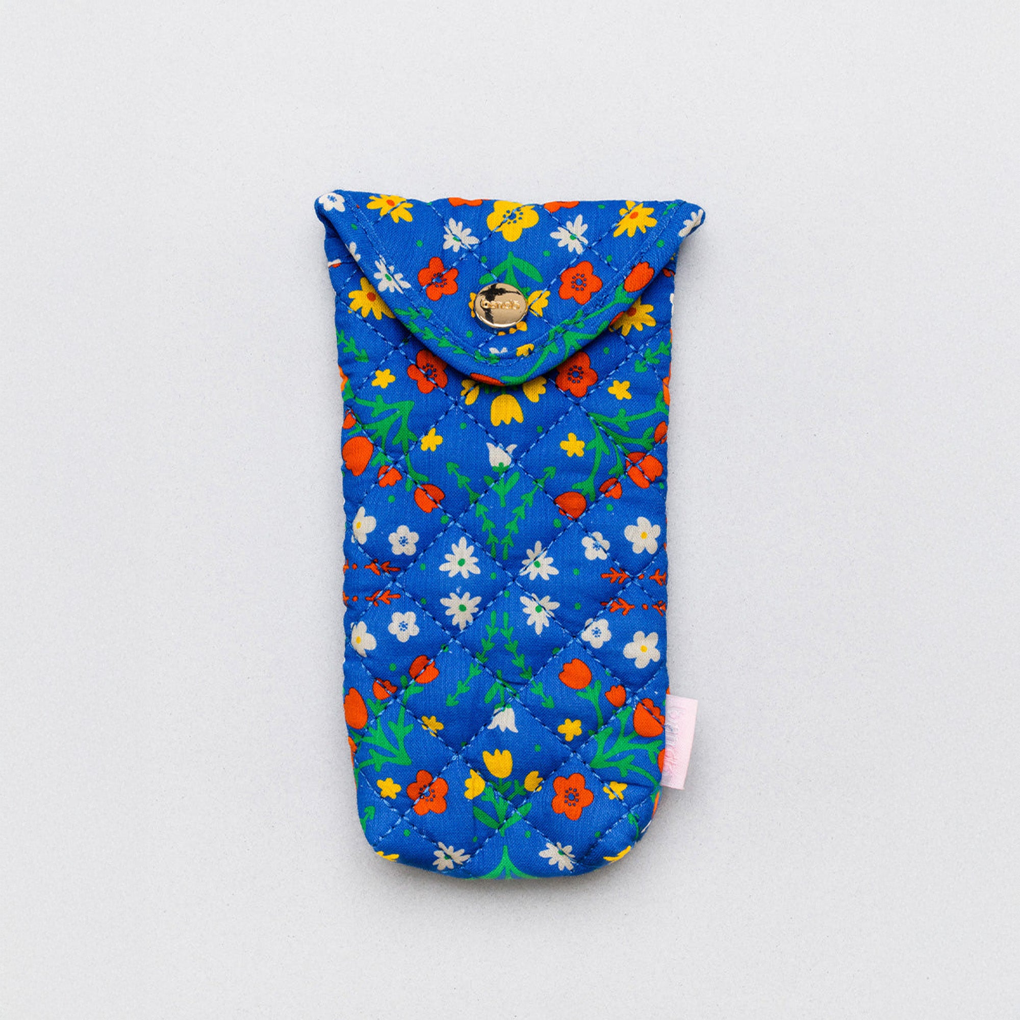 A quilted fabric sunglasses case with a blue background and a colorful floral print, shown on a light gray background with sunglasses inside.