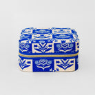 A square zippered storage box with a blue and cream floral block-print pattern, shown on a light gray background.