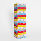 A tall stack of colorful rectangular boxes with a repeating floral pattern, photographed against a clean white studio background.