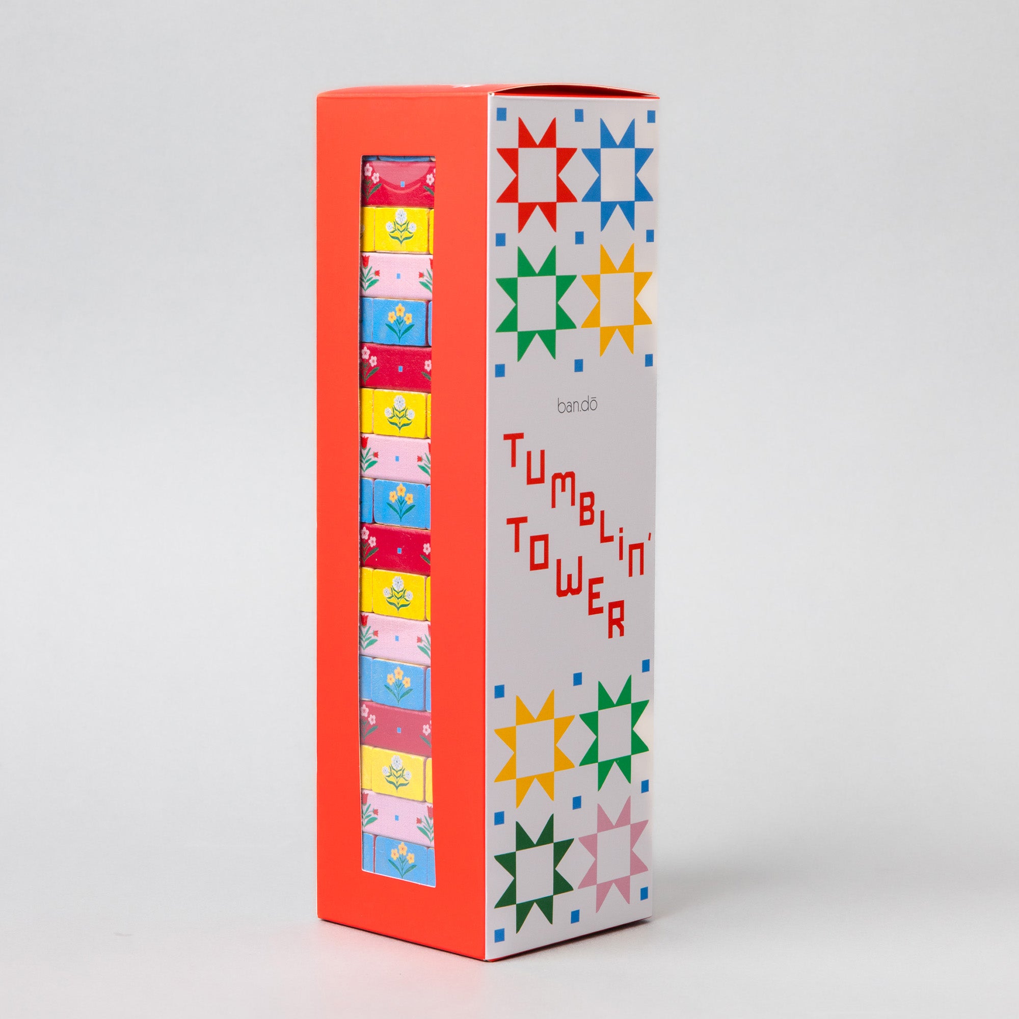 A tall rectangular product box standing upright on a light gray studio background. The box is mostly white on the front with colorful star and geometric patterns in red, blue, green, yellow, and pink, plus the visible brand name 'barco' and the product name 'TUMBLIN' TOWER' in red.