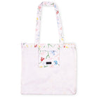 A white tote bag with a multicolor floral and butterfly print on the handles, top trim, and front pocket, shown against a plain white background.