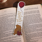 Bookmark with a bear and balloon design on an open book