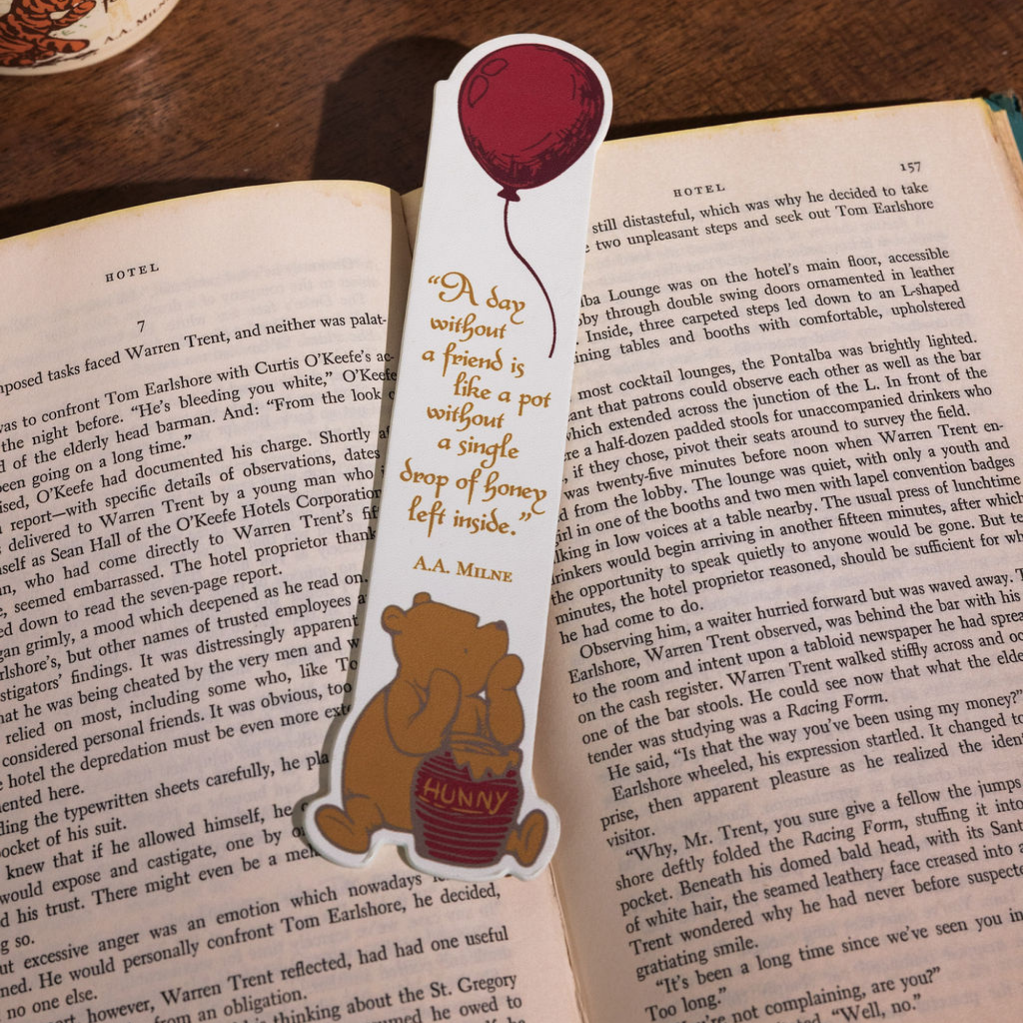 Bookmark with a bear and balloon design on an open book