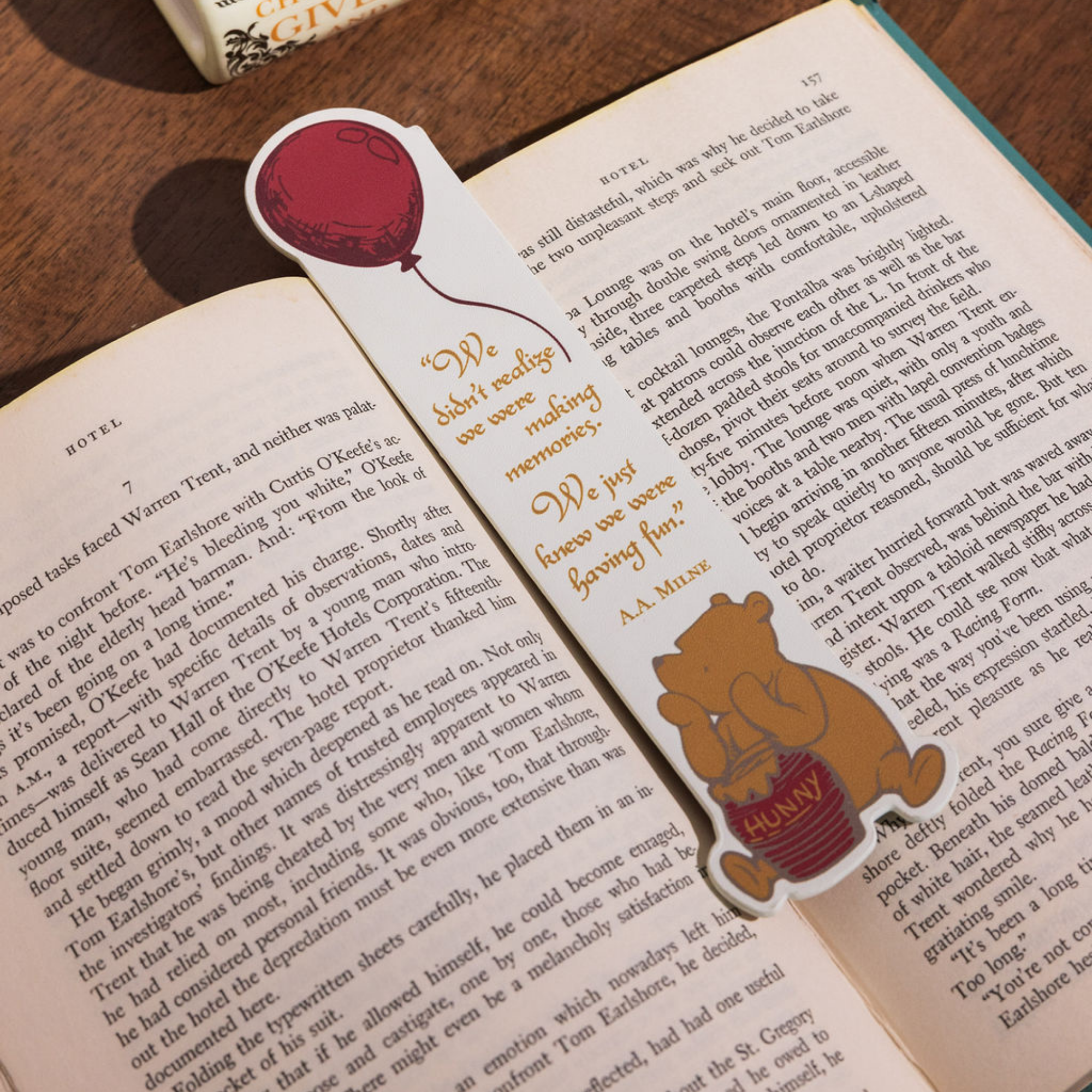 Bookmark with Winnie the Pooh and a balloon on an open book