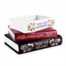 Stack of books with 'Pride and Prejudice' on a white background
