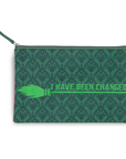Green pouch with pattern and text 'I HAVE BEEN CHANGED' on a white background