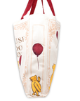Bag with Winnie the Pooh design featuring a red balloon on a white background