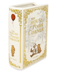 Book-shaped container with 'The House at Pooh Corner' design on a white background