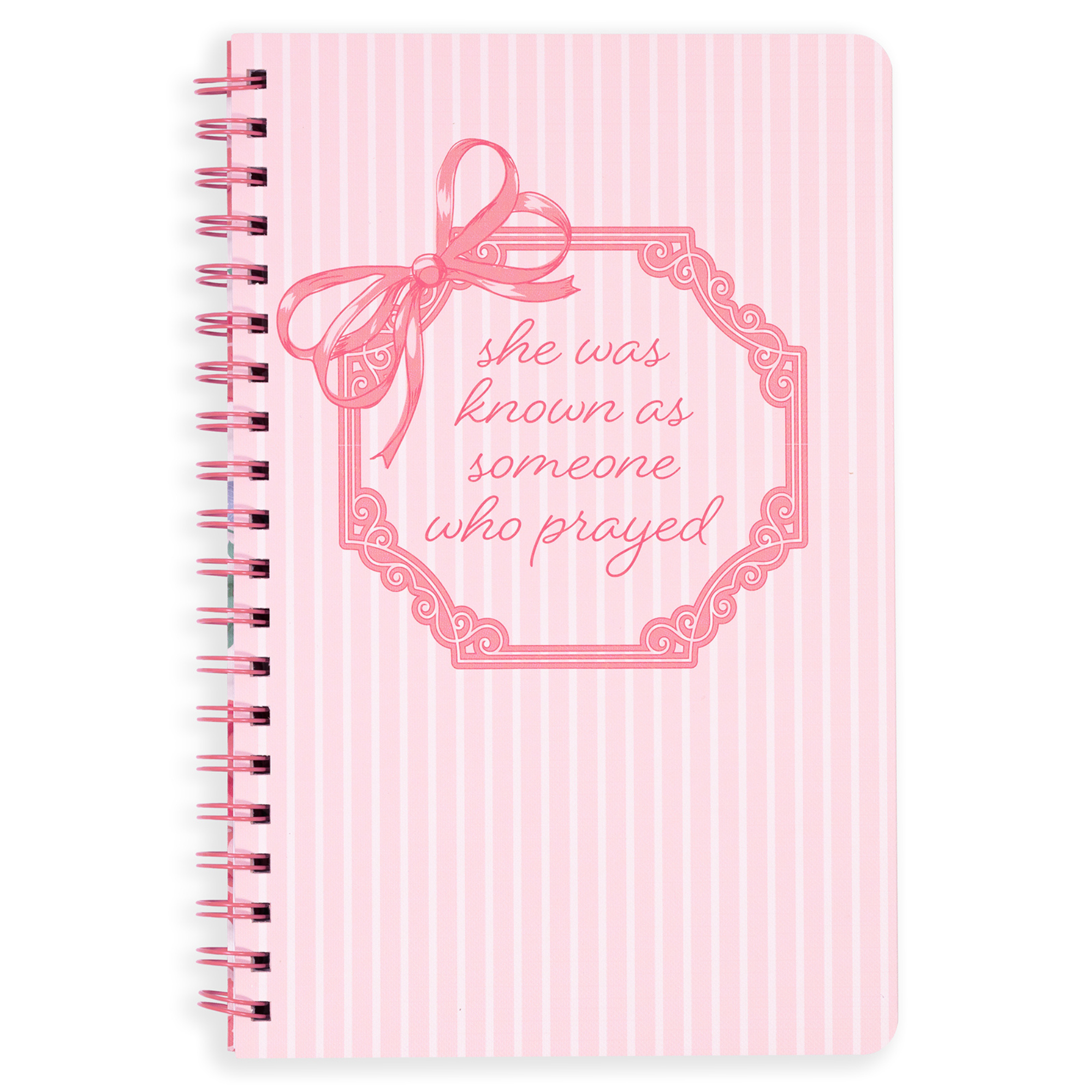 Pink notebook with decorative bow and text on a white background