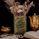 Book titled 'Pride and Prejudice' by Jane Austen with decorative elements on a dark background