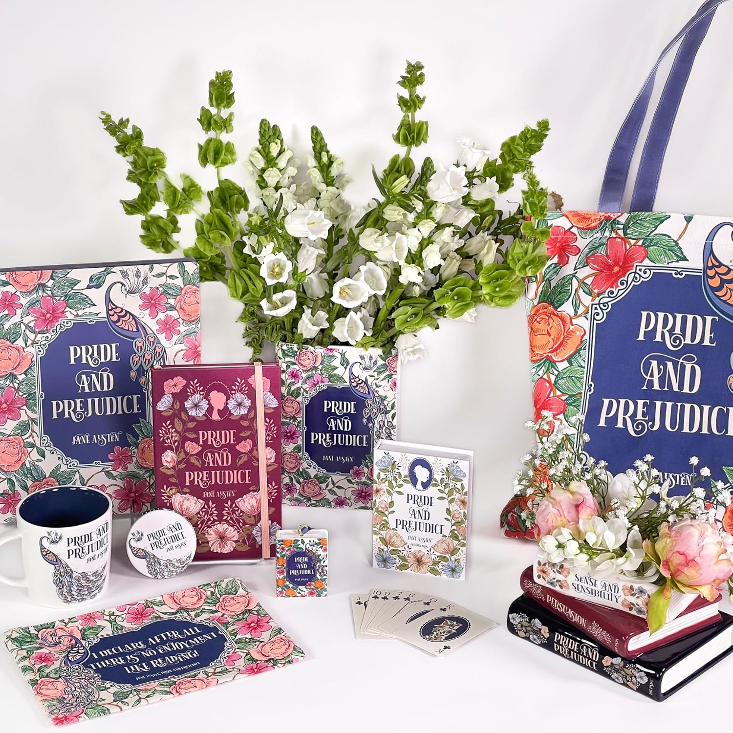 Collection of 'Pride and Prejudice' themed books, mugs, and decor items on a white background with flowers.