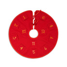 A red circular Christmas tree skirt with a central hole, featuring twelve numbered fabric squares in yellow numerals 1 through 12 around the outer edge.