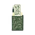 Stationery set with green floral design including a pen, paper, and holder on a white background.
