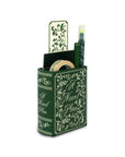 Green book-shaped desk organizer with stationery items on a white background