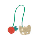back view of gold mask with green strap and red rose on a white background