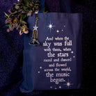 Keychain with mountain and star charms  on a navy tote