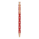 A red retractable pen with a white teddy bear pattern and gold-toned accents, shown vertically against a plain white background.