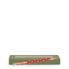 Boxed red retractable pen with a white teddy bear pattern and gold-toned accents, shown vertically against a plain white background.
