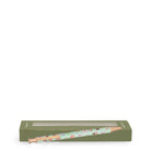 A decorative ballpoint pen with a light green patterned barrel and rose gold metal tip, resting on top of its olive green packaging box against a white background.
