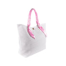 side view of white mesh tote beach bag with pink and white floral handles