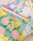 Colorful floral and abstract patterned bags on a matching background