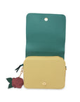 Green and beige crossbody bag with a decorative rose charm on a white background