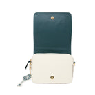 A two-tone crossbody bag with a dark teal upper flap and an off-white lower body, featuring gold-tone hardware and a decorative key charm.