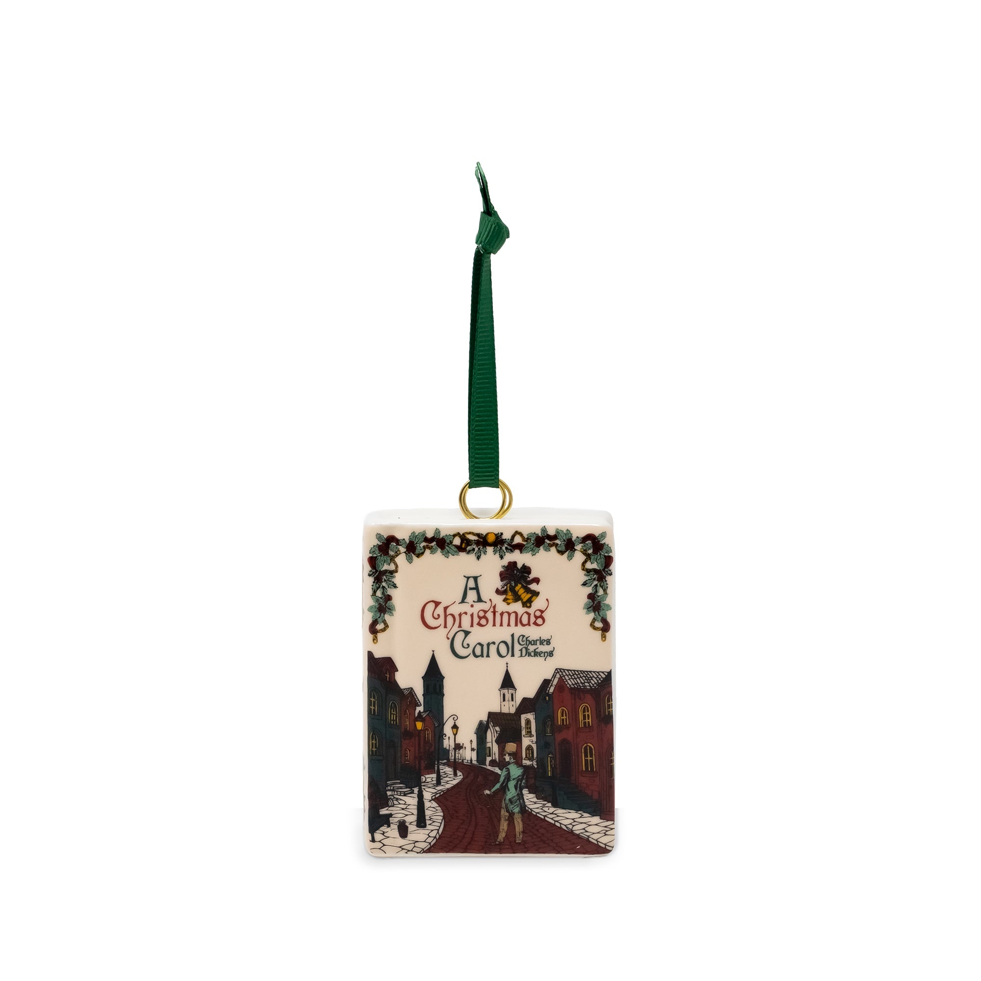 A square Christmas ornament featuring an illustrated winter street scene from 'A Christmas Carol' with a green hanging ribbon and gold loop.