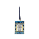 A rectangular hanging ornament with a dark blue ribbon loop, featuring a cream background with blue and gold decorative borders and printed text about the Holy Trinity, shown on a plain white background.