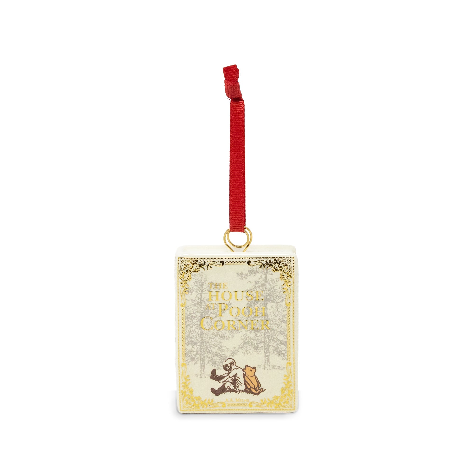 A decorative Christmas ornament shaped like a vintage book cover featuring a red hanging ribbon and gold ornamental border details on a white background.