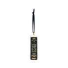 Spine of a decorative book-shaped ornament featuring the title 'A Silent Night' in gold lettering, decorated with a dark navy blue and gold pattern of birds, stars, and musical notes. It has a hanging loop at the top and is shown on a plain white background.