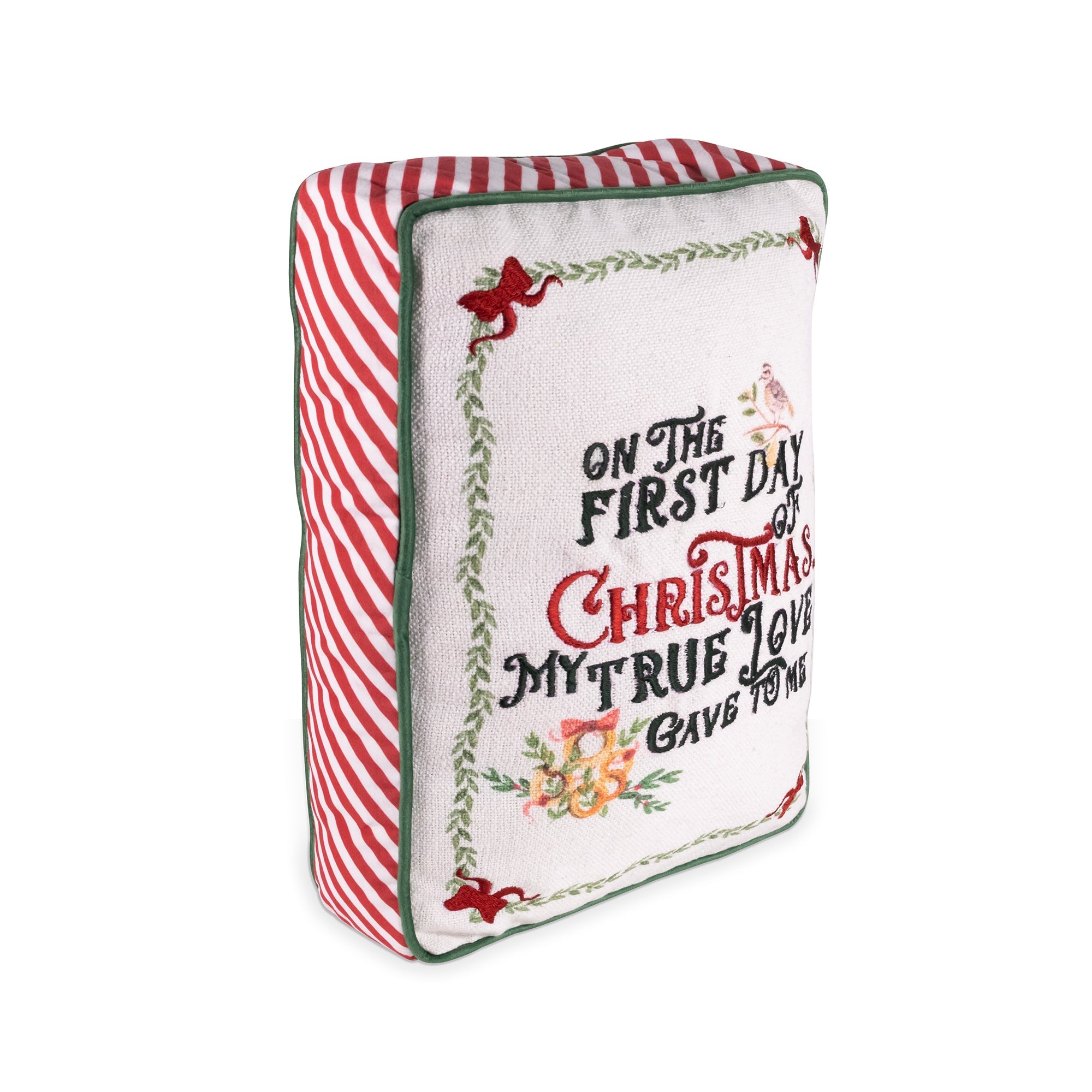 A square decorative throw pillow with a festive Christmas design. The front features a white background with embroidered-style text reading 'ON THE FIRST DAY OF CHRISTMAS MY TRUE LOVE GAVE TO ME' in green and red lettering, surrounded by a green vine border with red bows and small floral details.